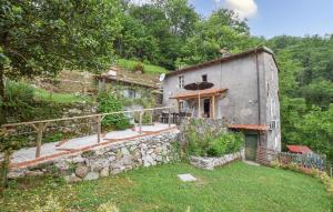 an old house with a stone wall next to a yard at Casa Sant'anna in Stazzema +16 photos