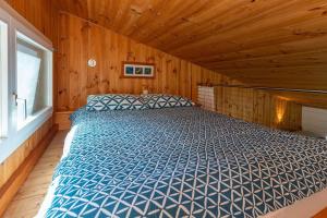 a bedroom with a bed in a wooden room at The Deck in Elizabeth Beach