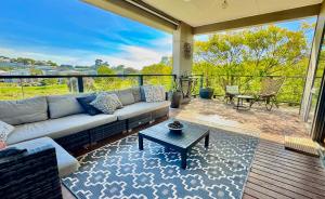 a living room with a couch and a table at Coastal Tones - Designer Beach house - Pets Welcome - Huge Yard - Walk to Beach in Cowes