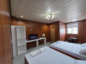 a bedroom with two beds and a tv in it at MSD Resort Hotel in Bengcag