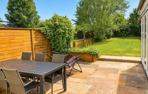 a patio with a wooden table and chairs at 3 Bedroom Gorgeous Home In Faaborg in Faaborg