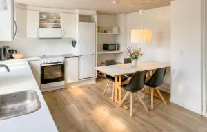 a kitchen with a table and chairs in a kitchen at 3 Bedroom Gorgeous Home In Faaborg in Faaborg