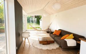 a living room with a couch and a table at 3 Bedroom Gorgeous Home In Faaborg in Faaborg +10 photos