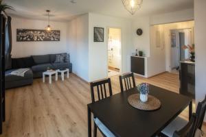 a living room with a table and a couch at Ferienwohnung Kaiserblick in Anger