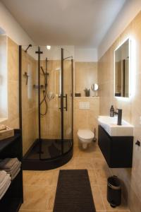 a bathroom with a shower and a toilet and a sink at Ferienwohnung Kaiserblick in Anger +21 photos