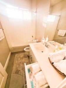 a bathroom with a sink and a toilet and a mirror at Vip Class One Real Comfort 3 Bedrooms in Lodi +11 photos