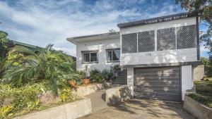 a white house with a garage at Iconic Escape Nowra in Nowra