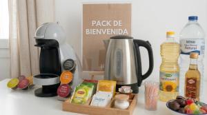 a kitchen counter with a coffee maker and some food at Apartalux Palacio del Mar in Algeciras