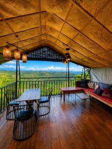 a living room with a table and chairs and a view at Thrill Playgrounds & Tipi Cafe in Libona