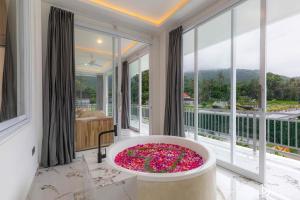 a bathroom with a large tub filled with flowers at Made's Dream Villa Amed in Amed