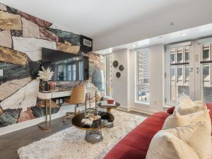 a living room with a couch and a desk at Regis Suites - Downtown Toronto in Toronto