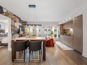 a kitchen and dining room with a table and chairs at Regis Suites - Downtown Toronto in Toronto