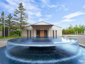 a water fountain in front of a building at Tateshina Lake Resort in Tateshina