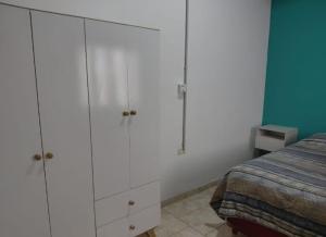 a bedroom with white cabinets and a bed at CATALINA in Neuquén