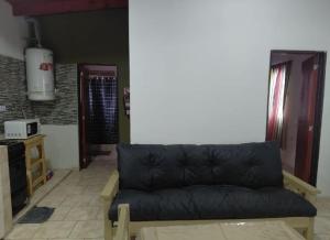 a living room with a black couch and a table at CATALINA in Neuquén
