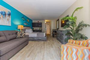a living room with a bed and a couch at Landmark 618 in Myrtle Beach