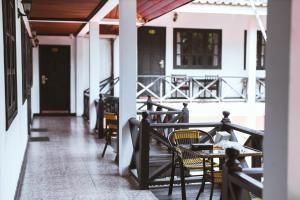 a patio with chairs and tables on a porch at Vientiane Garden Villa Hotel in Vientiane