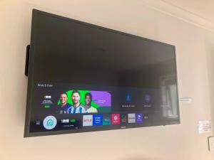 a flat screen tv hanging on a wall at Tripinn Botique Motels & Affordable Accommodation in Westport