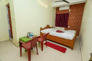 a bedroom with a bed and a table and chairs at Silver residency in Bhubaneshwar