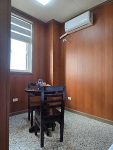 a dining room with a table and a air conditioner on the wall at MSD Resort Hotel in Bengcag