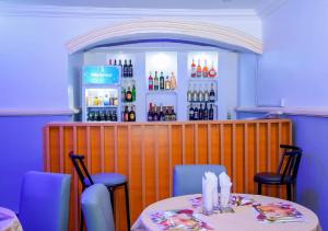 a bar with a table and chairs in a restaurant at Executive Private Bed and Bath in Otta