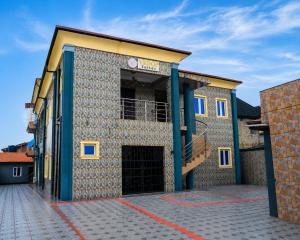 a building with a gate and a building with a stair at Executive Private Bed and Bath in Otta