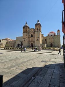 an old building with people walking in front of it at Casa Centro Historico Hostel in Oaxaca City
