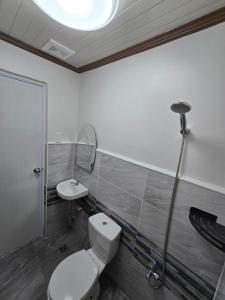 a bathroom with a toilet and a sink at MSD Resort Hotel in Bengcag +36 photos