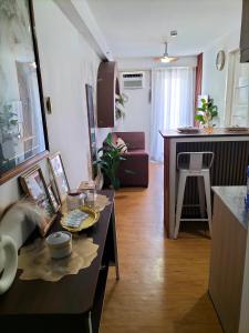 a living room with a table and a kitchen at Casa Bonita Davao in Davao City