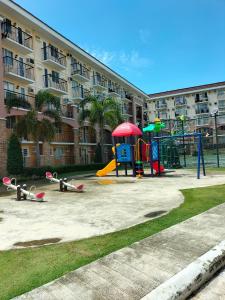 a playground in front of a large apartment building at Casa Bonita Davao in Davao City