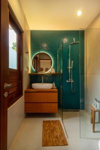 a bathroom with a sink and a mirror at Coco Luxury Villas in Ubud +21 photos