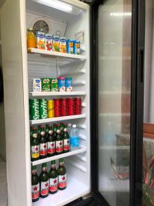 an open refrigerator filled with lots of drinks at Naomi Homestay in Padangbai