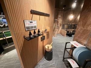 a room with a bathroom with a shower at HOTEL LiVEMAX BUDGET Hiratsuka Ekimae in Hiratsuka