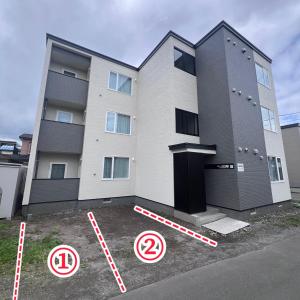 a building with no parking signs in front of it at イーエフ千歳駅 in Chitose