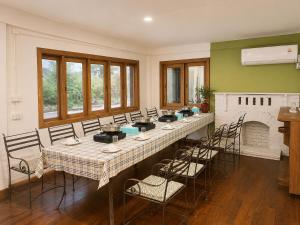 a large dining room with a long table and chairs at Ping Dara Pool Villa Party in Ban San Pa Sak