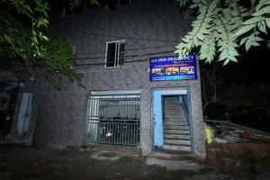 a building with a gate and a blue sign at Silver residency in Bhubaneshwar