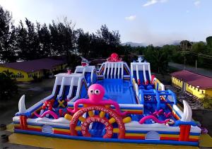 an inflatable water park with an octopus and other toys at CBR Beach in Kota Belud