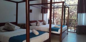 a bedroom with two bunk beds and a balcony at Lavish Resort Sigiriya in Inamaluwa +11 photos