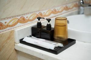 a bathroom with a sink and a lamp on a counter at Tân Trang in Ha Long