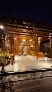 a pavilion with a table and a table and benches at Nara Housee' in Darmasaba