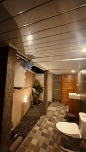 a bathroom with two toilets in a room at Nara Housee' in Darmasaba +1 photo