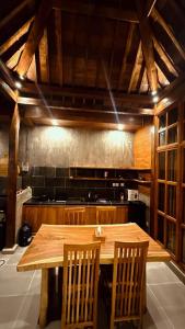 a kitchen with a wooden table and two chairs at Nara Housee' in Darmasaba