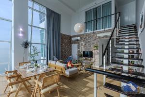 a living room with a fireplace and a staircase at Maritime in George Town