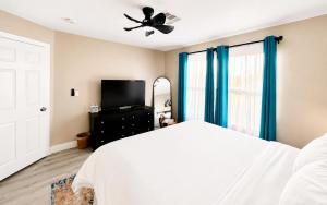 a bedroom with a bed and a ceiling fan at No Added Fees! Craig Ranch HomeShare Retreat in Las Vegas