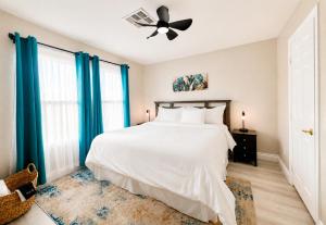 a bedroom with a white bed and a ceiling fan at No Added Fees! Craig Ranch HomeShare Retreat in Las Vegas