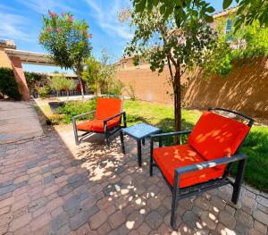 two chairs and a table on a patio at No Added Fees! Craig Ranch HomeShare Retreat in Las Vegas