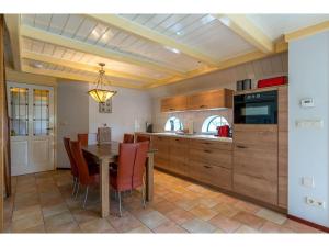 a kitchen with a table and chairs in a room at Lovely Holiday Home in Texel near Sea in Oost