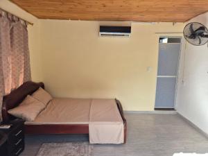 a small bedroom with a bed and a window at Brisas Alojamiento in Gualanday