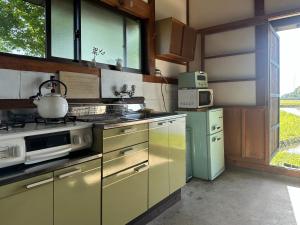 a kitchen with a stove and a stove top oven at sikari Vacation STAY 95401v in Takashima