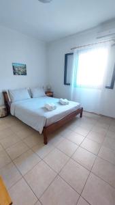 a bedroom with a bed with two towels on it at Giannos Apartments in Agia Effimia